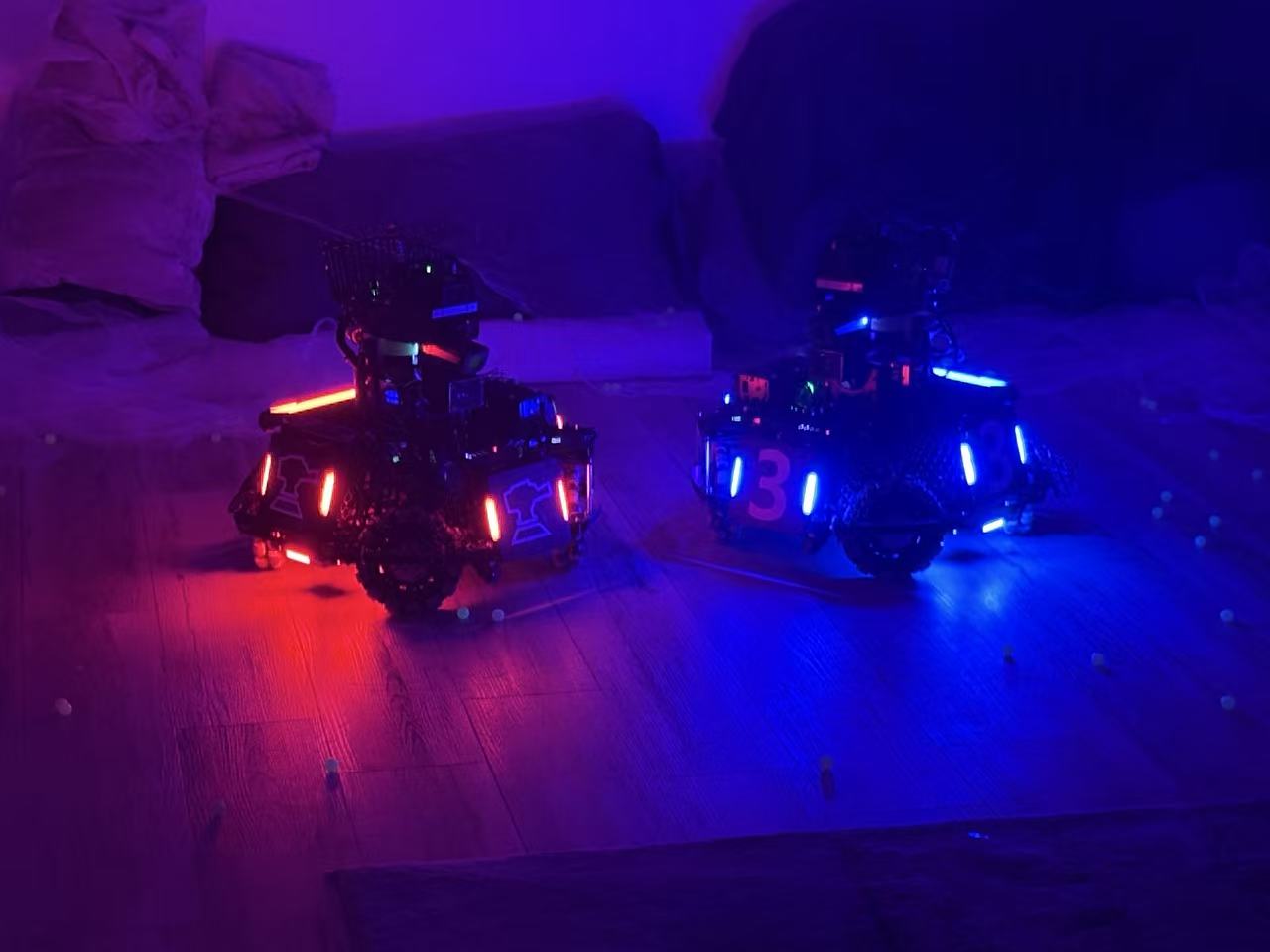Two of our robots facing off, one lit red and one lit blue